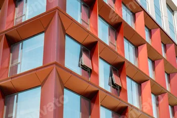 Modern office building exterior with glass facade on clear sky background. Transparent glass wall of
