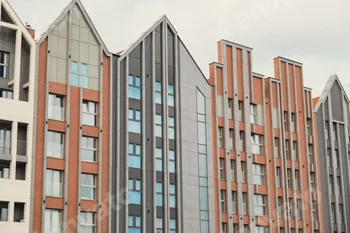 Modern office building exterior with glass facade on clear sky background. Transparent glass wall of