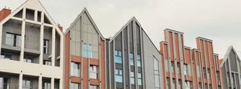 Modern office building exterior with glass facade on clear sky background. Transparent glass wall of
