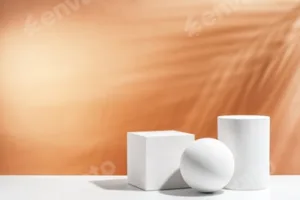 White geometric shapes arranged stylishly on a soft peach background in a minimalist setting