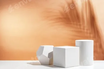 White geometric shapes arranged stylishly on a soft peach background in a minimalist setting