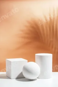 White geometric shapes arranged stylishly on a soft peach background in a minimalist setting