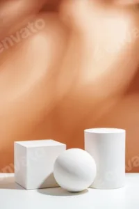 White geometric shapes arranged stylishly on a soft peach background in a minimalist setting
