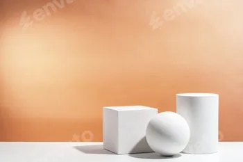 White geometric shapes arranged stylishly on a soft peach background in a minimalist setting