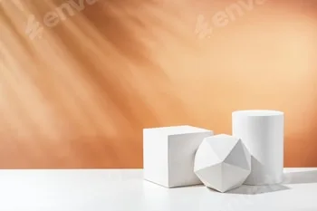 White geometric shapes arranged stylishly on a soft peach background in a minimalist setting