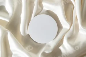 Modern Minimalist White Sculpture Displayed on Soft Draped Fabric in Natural Light