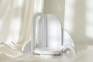 Modern Minimalist White Sculpture Displayed on Soft Draped Fabric in Natural Light