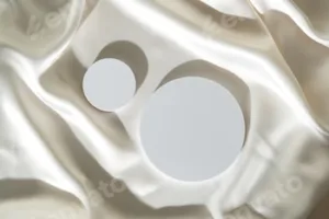 Modern Minimalist White Sculpture Displayed on Soft Draped Fabric in Natural Light