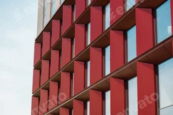 Modern office building exterior with glass facade on clear sky background. Transparent glass wall of