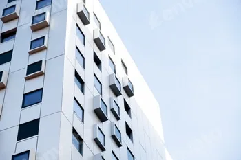 Modern white building with square windows. Multistory apartment building. Minimalistic Stylish