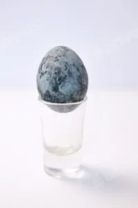 one blue egg. Close up Easter egg pastel colored on white background. Minimal Easter celebration con