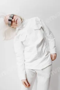 Futuristic fashion portrait with an avant garde white outfit, featuring a model with sleek hair and