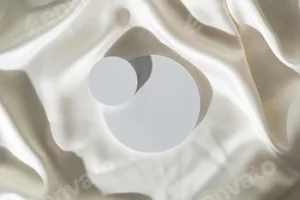 Modern Minimalist White Sculpture Displayed on Soft Draped Fabric in Natural Light