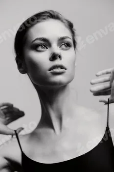 Elegant young woman with a graceful pose, showcasing confidence in a black outfit against a soft 5 Elegant young woman with a graceful pose, showcasing confidence in a black outfit against a soft