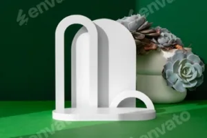 Modern White Geometric Sculpture With Succulents On A Green Table Surface