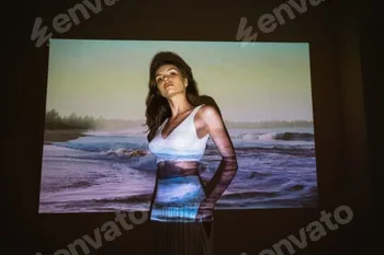Young adult woman 20 years old with projected image of ocean or see in neon colors