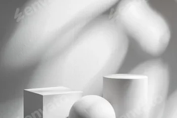 Abstract composition featuring three white geometric shapes in a minimalist interior setting