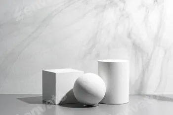 Abstract composition featuring three white geometric shapes in a minimalist interior setting