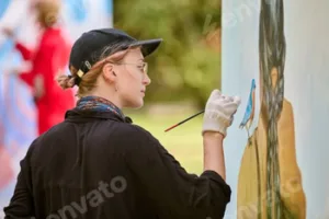 Young woman engaged in en plein air painting on sunny day