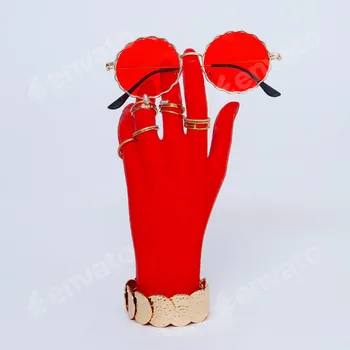 Plastic hand in fashion jewelry accessories and sunglasses.. Stylish fashion concept